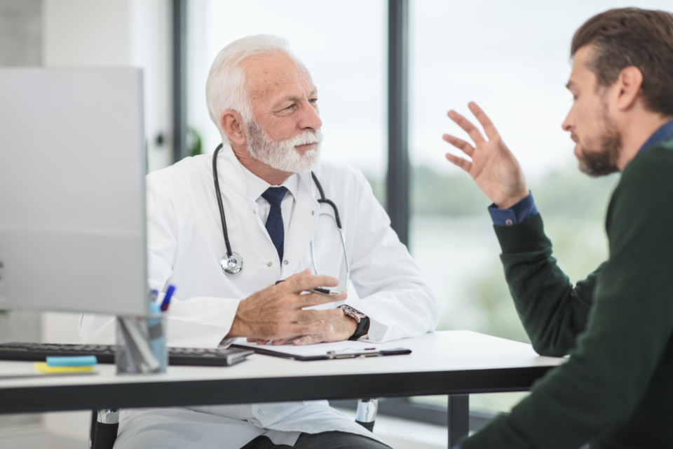A doctor listening to a patient during a consultation